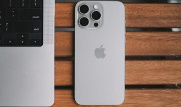 My iPhone 15 Pro Max and a laptop on a table